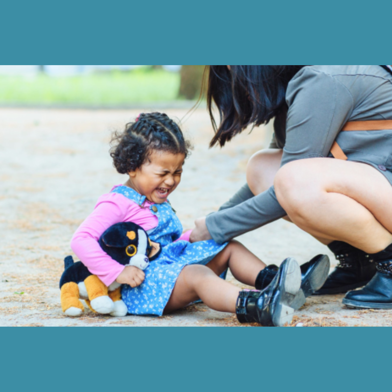 Teacher helping child experiencing big feelings and supporting her emotional regulation in an inclusive early childhood classroom